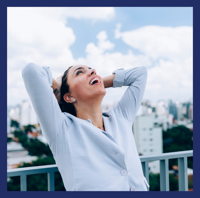 Woman with her hands on the back of her head looking relieved