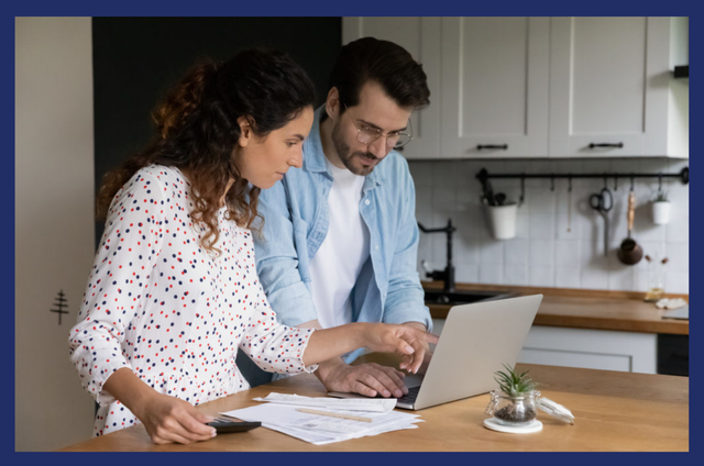 Couple looking at a computer searching for the refinancing loan process