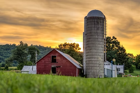 red barn at sunset on rural property