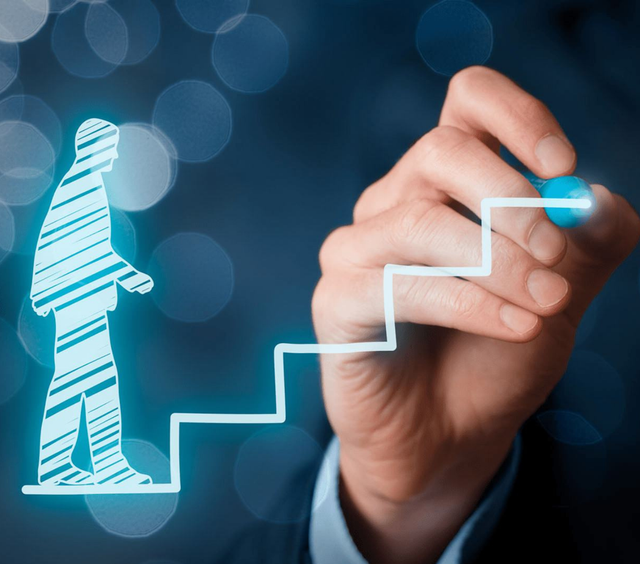 Man writing stairs on a board to show upward career trajectory
